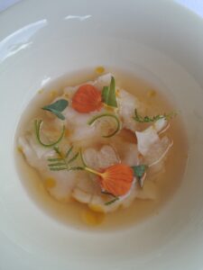Braised Monkfish with sea buckthorn oil, daikon, and a garden herb tea infused with lemon balm