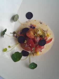 Tomato and Melon Salad with gochugaru (Korean chili pepper) oil and aged Rotterdam cheese sauce