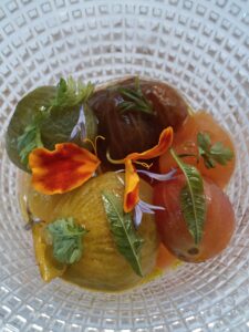 Semi-dried cherry tomatoes and peach in chilled tomato tea with fresh herbs.