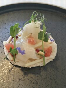 Kohlrabi strips, almond cream, Grapefruit, pine nuts