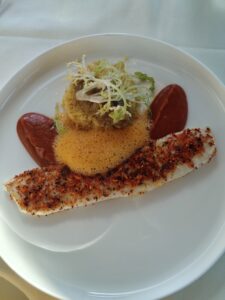 Swiss Alpine Zander (Pike-Perch) – Fried and served with couscous, spicy Nduja, paprika, and baba ganoush.